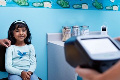 Spot Vision screener screening little girl in office