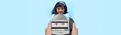 A Welch Allyn Spot Vision Screener shown being used on a smiling child