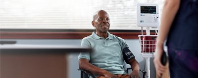 A man smiles while his blood pressure is measured using the Welch Allyn Spot Vital Signs 4400 Device