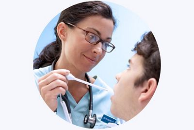 A nurse supports a patient’s hand while taking an SpO2 reading in an ICU setting
