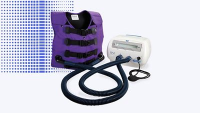 The Vest® Airway Clearance System, Model 105, attached with hoses to vest in Color Me Purple