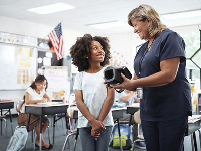  School-age girl looking at nurse