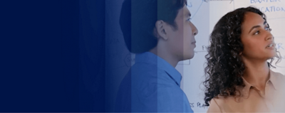 man and woman infront of a whiteboard looking at numbers