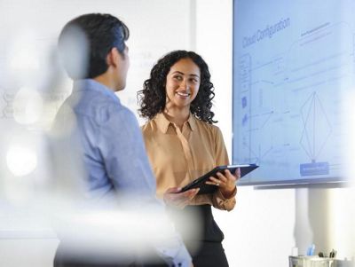 biomed it professionals pointing to whiteboard with numbers