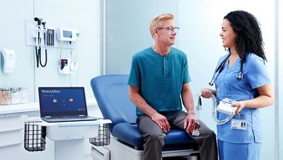 Clinician speaks with patient while holding a Wireless Acquisition Module (WAM™).