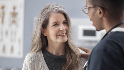 A nurse coaches a patient during a spirometry exam with the CP 150 Resting ECG with optional spirometry.