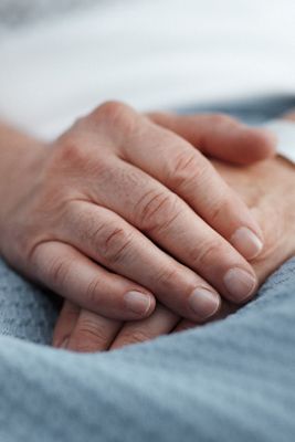 A close up of a patient's hands are shown with ID bracelet