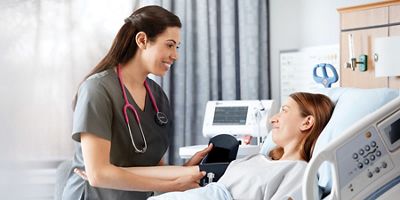 A clinician takes a patient's blood pressure.
