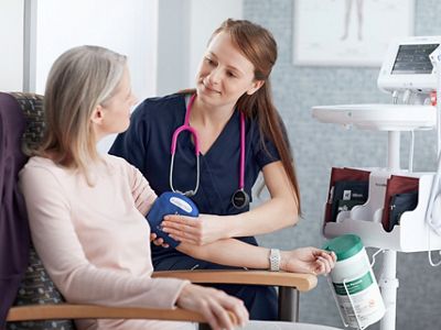 A clinician measures a patient’s blood pressure using a Welch Allyn Connex Spot Monitor from Hillrom