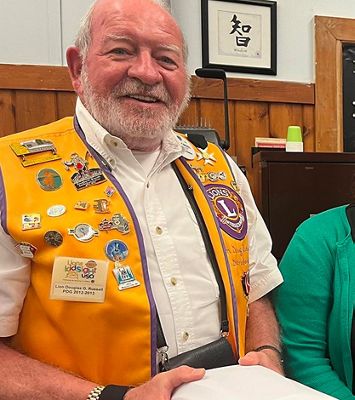 lions club member holding welch allyn retinavue 700 imager