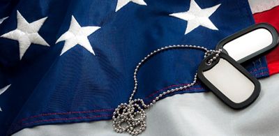 A set of dog tags placed on top of an American flag