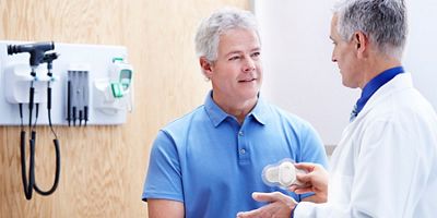 patient and doctor in conversation in an exam room