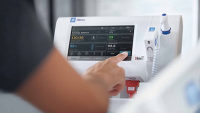 Caregiver using vitals monitoring device