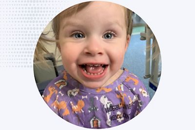 a young girl smiles in a primary care setting
