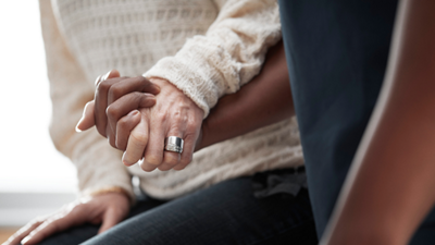 nurse and patient holding hands
