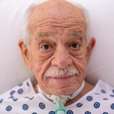older man in hospital bed with Volara system acute care