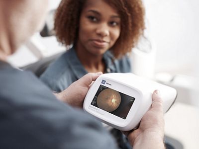 A clinician reviews the retinal image on the RetinaVue 700 Imager from a patient’s exam.