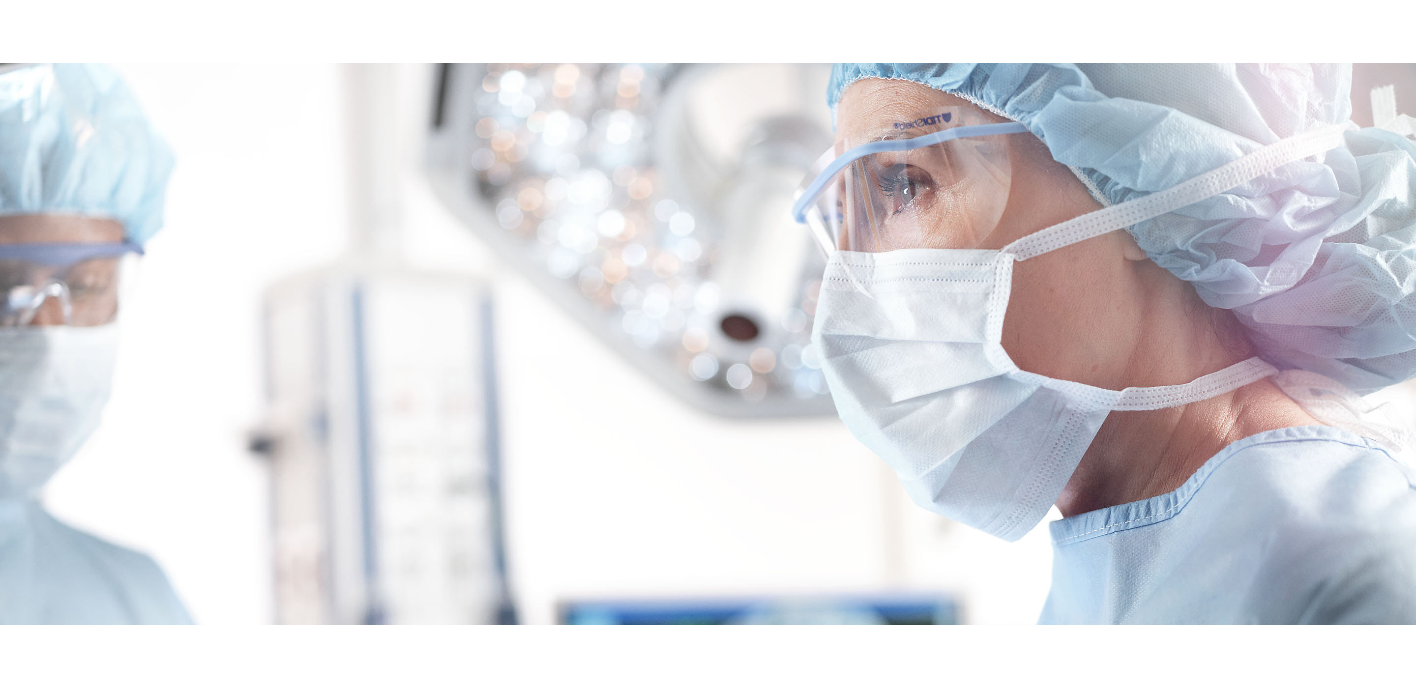 A surgical team member looks forward confidently