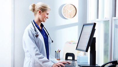 Clinician looks at a patient’s chart in the EMR.