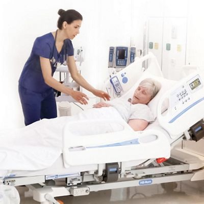Nurse attending to a patient in bed