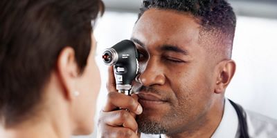 Doctor examining patient’s eye with the PanOptic Plus Ophthalmoscope