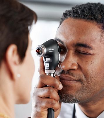 Doctor examining patient’s eye with the PanOptic Plus Ophthalmoscope