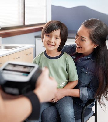 A caregiver using a Spot Vision Screener.
