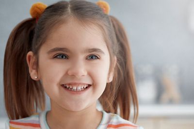 Young girl with pigtails smiles