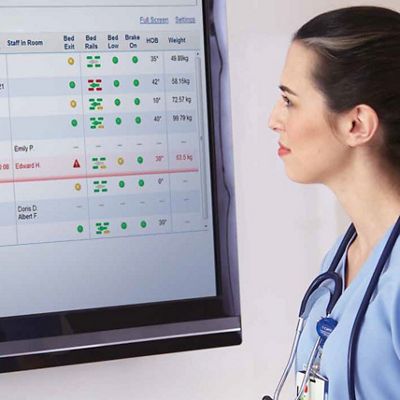 A nurse looking at statistics on a screen
