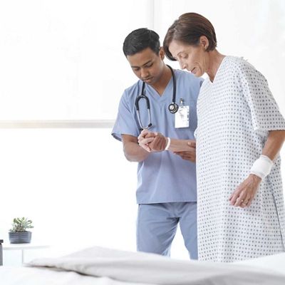 PSS Woman being helped out of bed