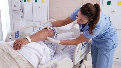 Nurse looking over patient