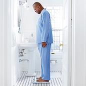 Patient standing on Welch Allyn Home Scale in bathroom