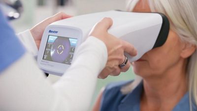 nurse performing exam on woman with the retinavue 700 imager