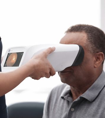 A clinician using a RetinaVue® 700 Imager on a patient. 