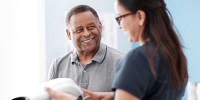 a patient and nurse smiling while using the RetinaVue 700 