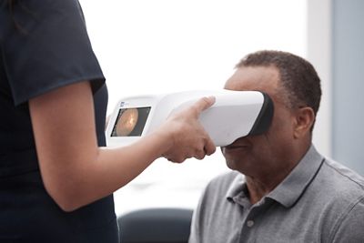 A clinician uses a Welch Allyn RetinaVue 700 Imager to complete a diabetic retinopathy exam