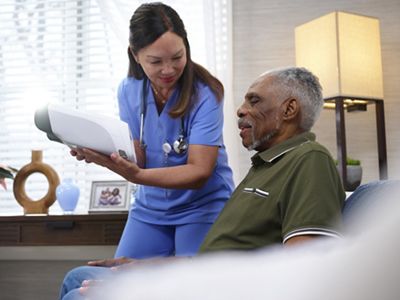 nurse with patient looking at the Welch Allyn RetinaVue 700 Imager