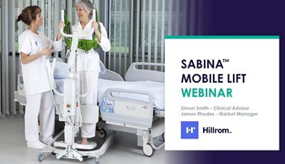 Close-up of doctor using tablet device in hospital hallway