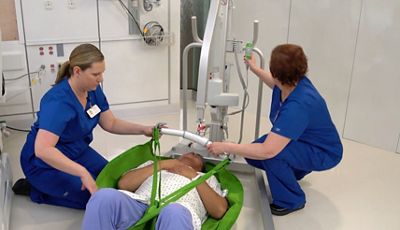 Close-up of doctor using tablet device in hospital hallway