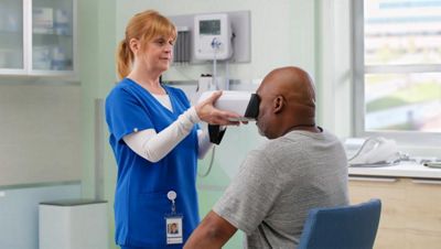 nurse performing eye exam with the welch allyn retinavue 700 imager 