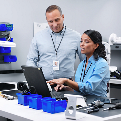 A clinician prepares to take a patient’s temperature using a Spot 4400 Vital Signs Device