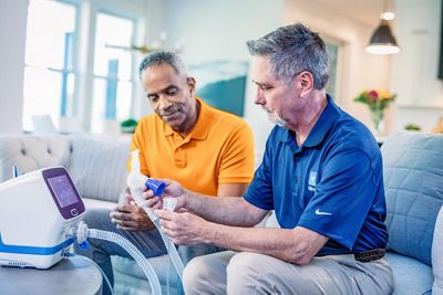 volara system: old therapy for home care being shown the device to a patient in the living room
