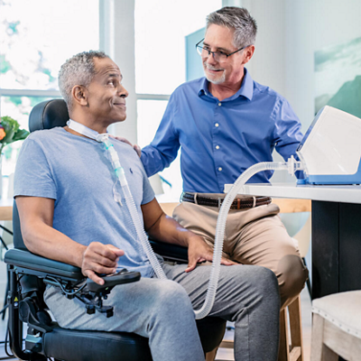 Volara system: old therapy for home care being utilized in the kitchen with older man in wheelchair